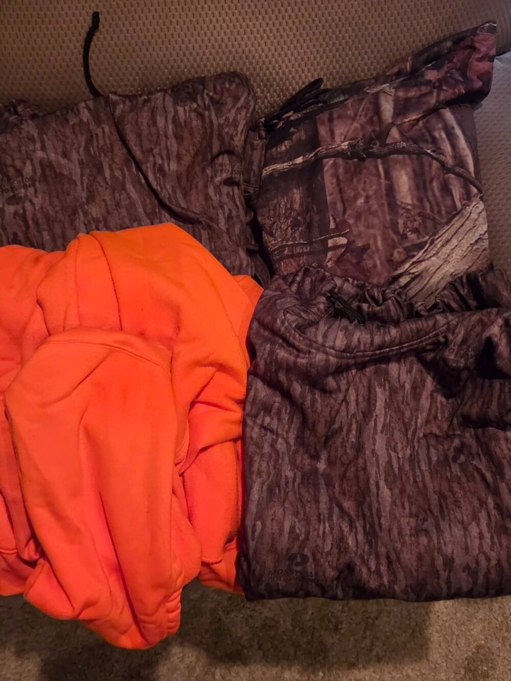 Camouflage and orange hoodies and vest